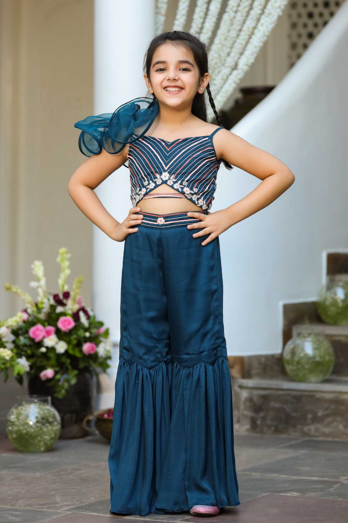 Buy Kids Designer Littleens Jumpsuit with ruffled organza flower on the shoulder, spaghetti straps, sweetheart neckline, and back zip closure with tiered and gathered sharara alongside an elasticated waist belt and double belt detailing on the bodice Online at ScrollnShops
