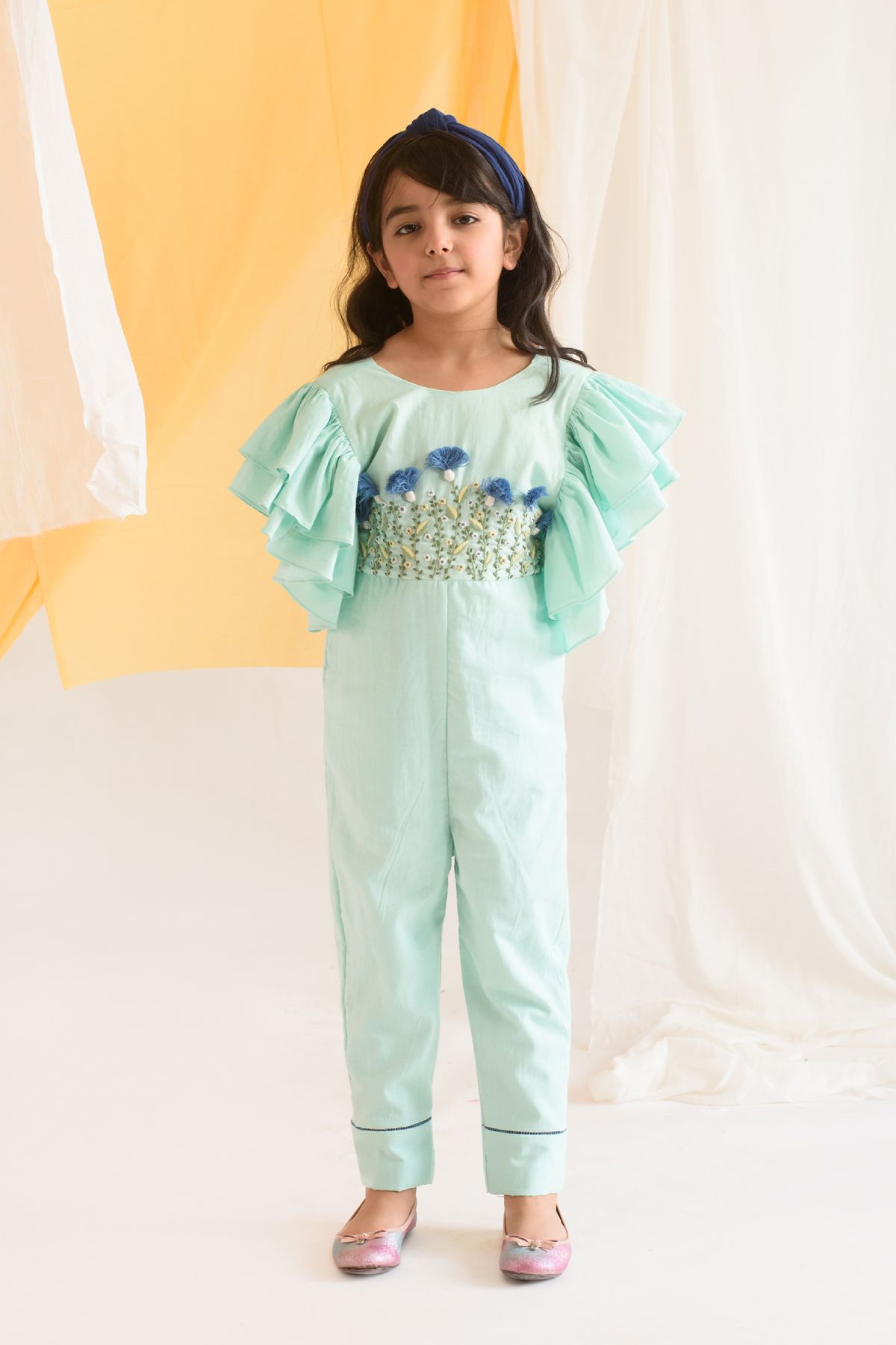 Buy Kids Designer Littleens Frilled straight fit jumpsuit with hand embroidery across the bodice, delicate fagoting at the hem, back bow details and elasticated back Online at ScrollnShops