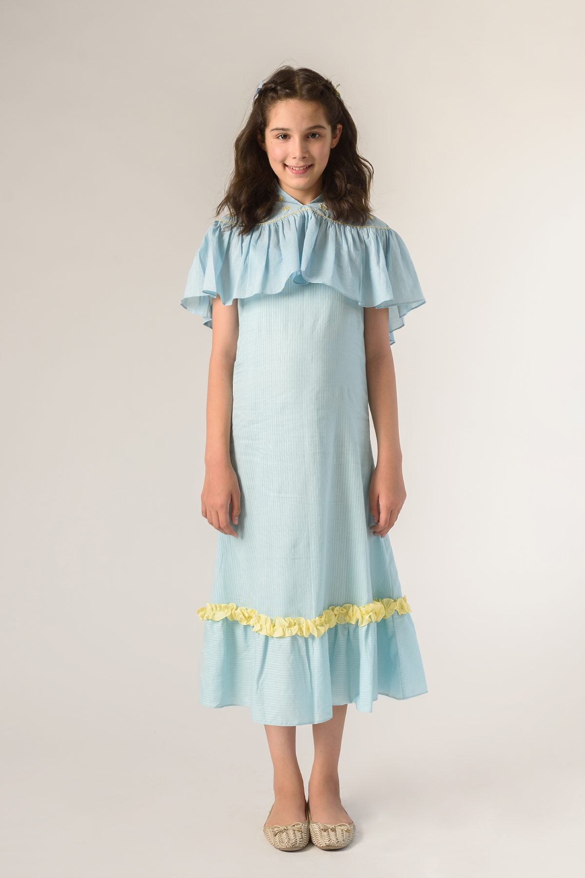 Buy Kids Designer Littleens Slip dress with mandarin collar yoke with embroidered florals, ru?ed cape adjourned with hand cross stitches, flared hemline with horizontal stripes featuring contrast frills Online at ScrollnShops