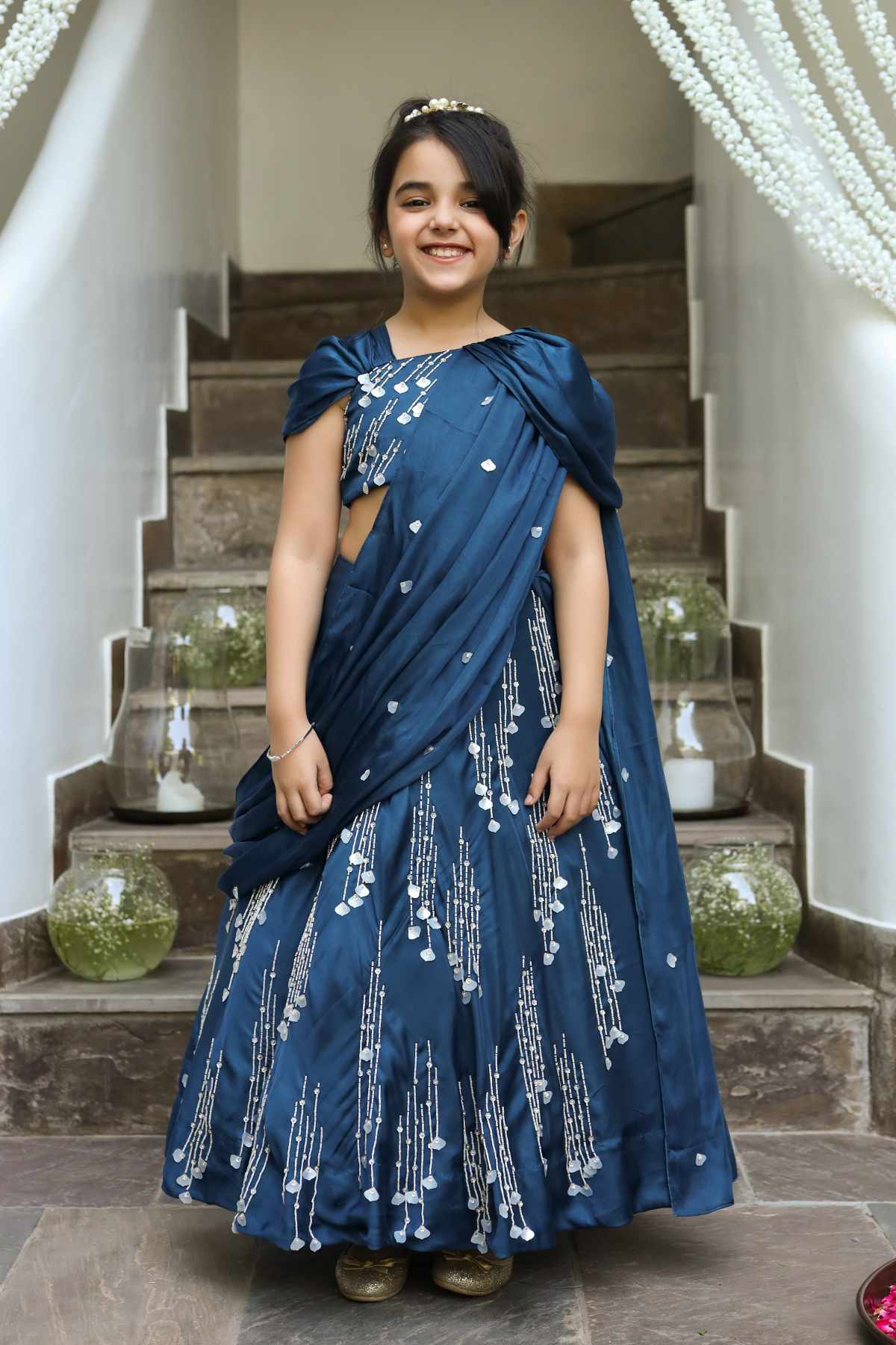 Buy Kids Designer Littleens Concept lehenga with pre-stitched drape with intricate embroidery paired with embroidered blouse with dramatic Grecian drapes extending from the shoulders Online at ScrollnShops