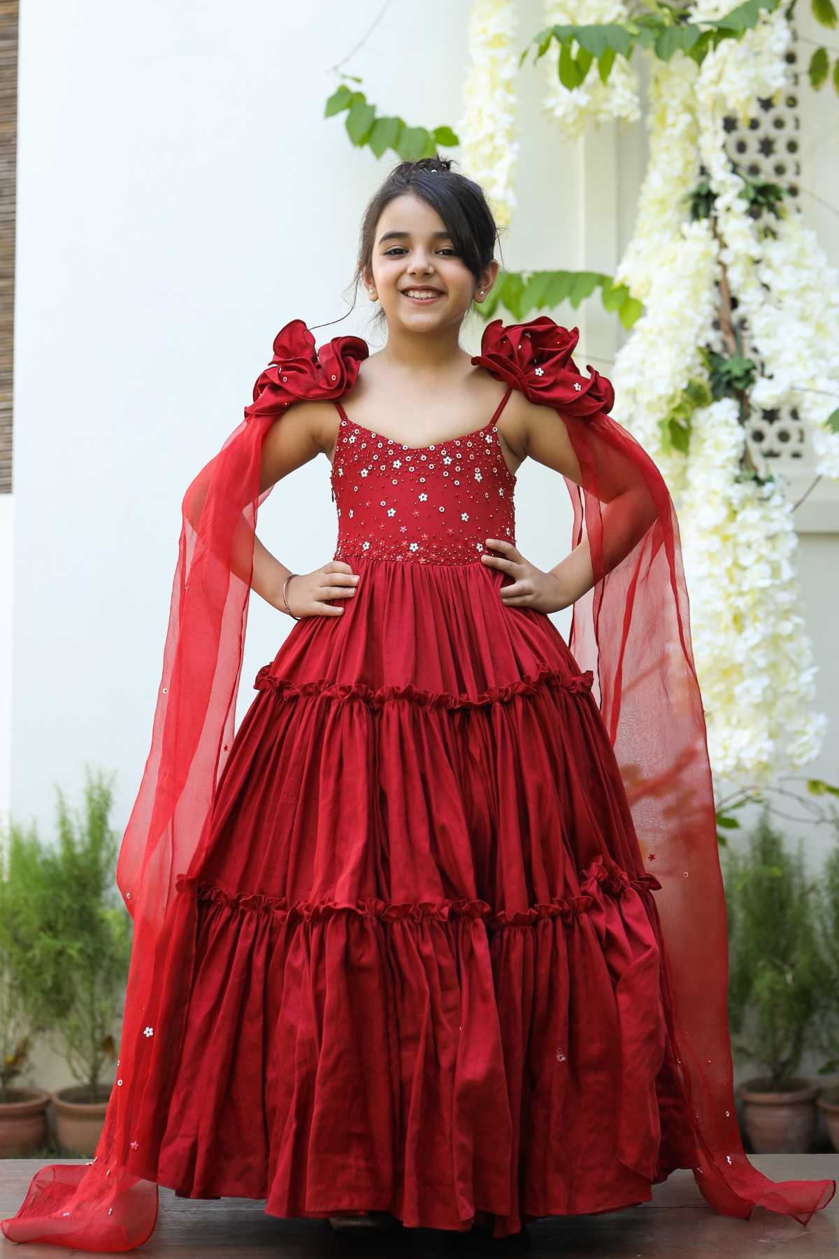 Buy Kids Designer Littleens Tiered style floral embroidered gown with sequins work embellishments on the bodice enhanced by draped long sleeves and delicate blooming rose on the shoulder Online at ScrollnShops